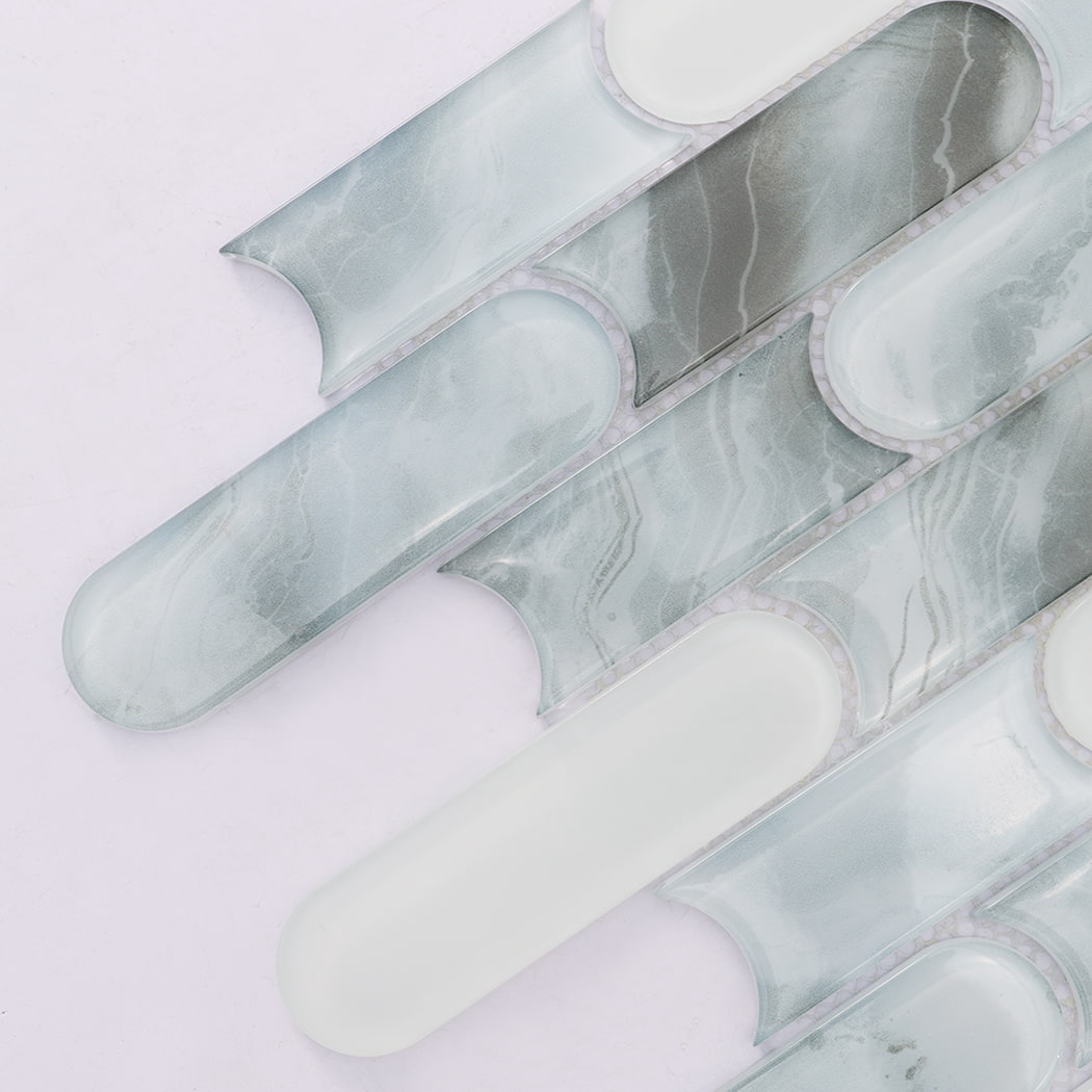 Close up of pale blue gray and white rounded linear glass mosaic tile pieces