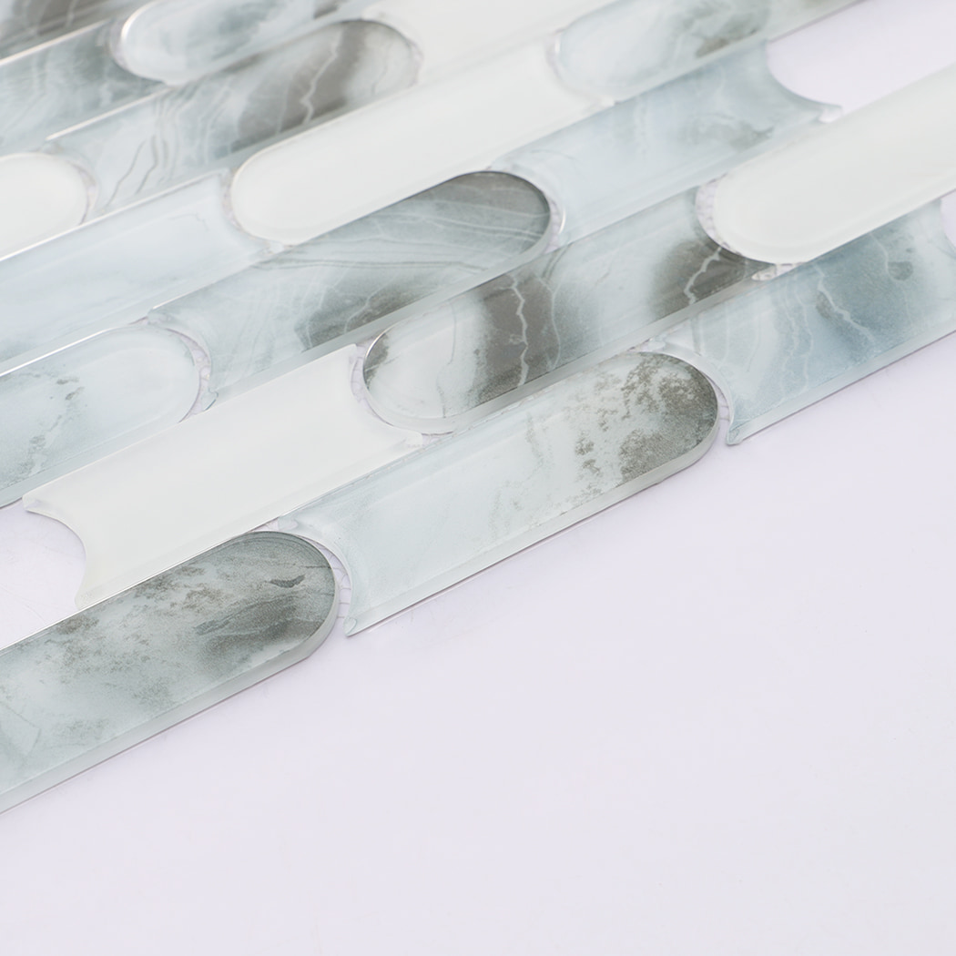 Detailed view of pale blue gray and white rounded linear glass mosaic pattern