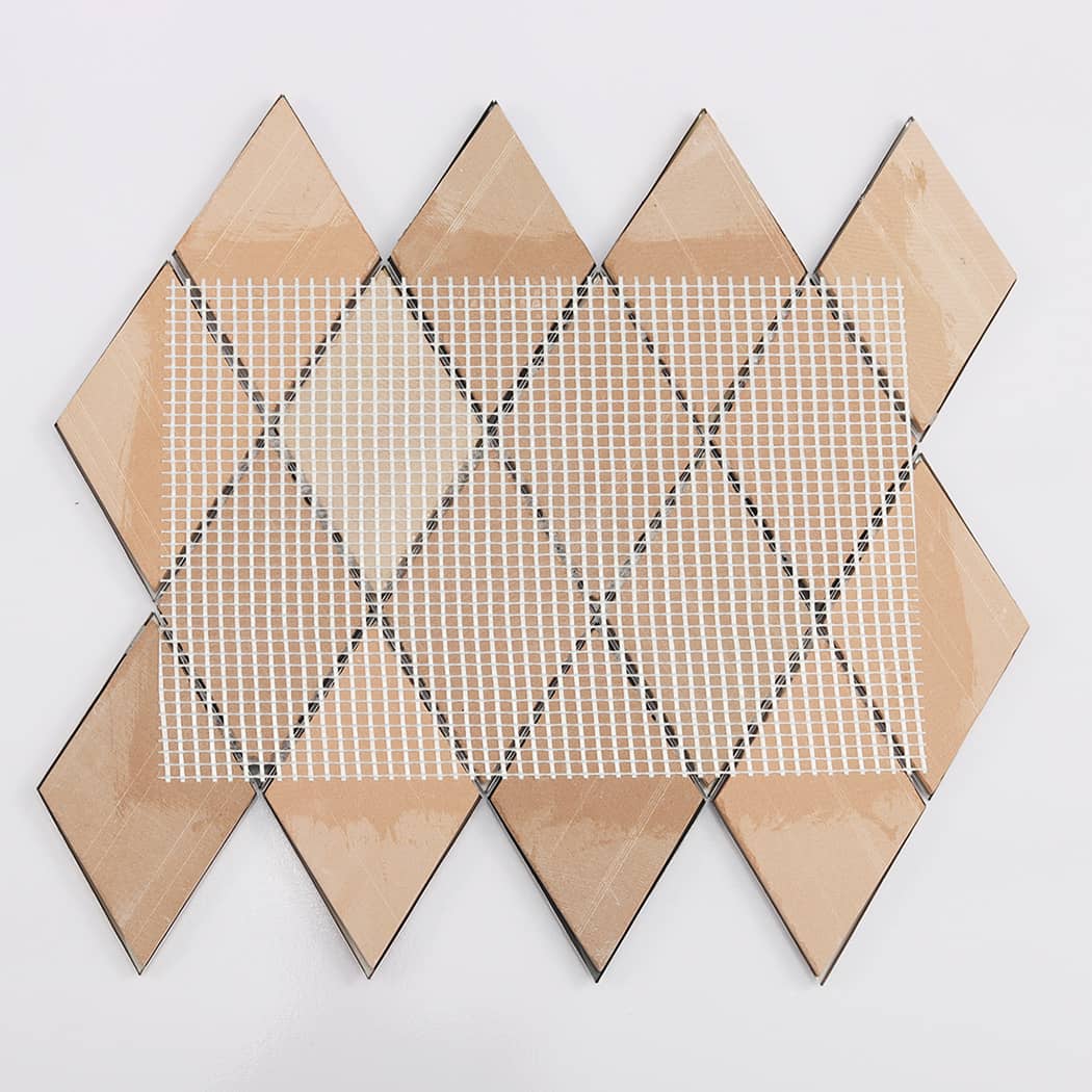 Back view of the diamond metal mosaic tile sheet showing the white mesh mounting.