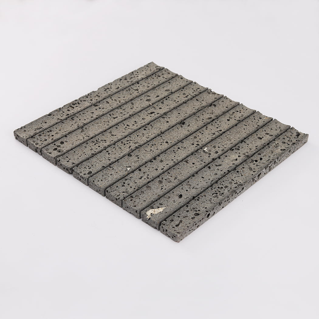 Perspective shot of a dark lava stone mosaic tile sheet on a white background.