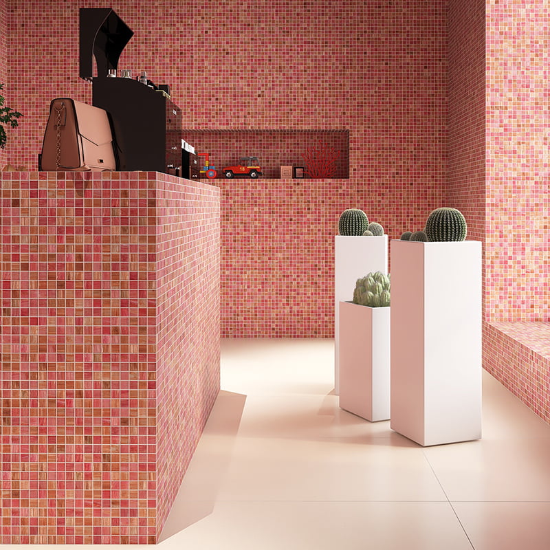 A close-up view of pink glass mosaic countertop with sparkling gold leaf backing