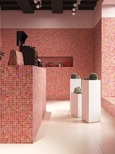 Modern white planters against a pink glass mosaic wall in showroom setting