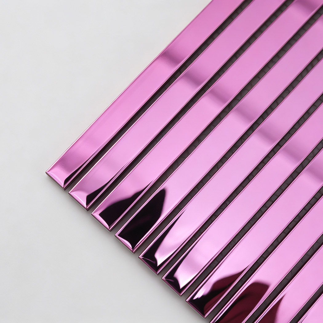 Corner close-up of pink mirror stainless steel pencil tile