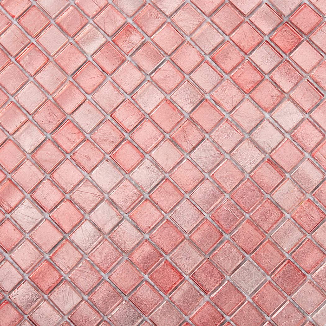 Close up view of textured square pink glass mosaic tiles