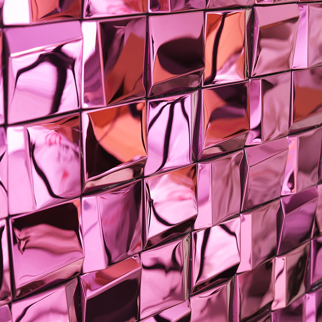 Close up of reflective pink mirror metal mosaic tile surface