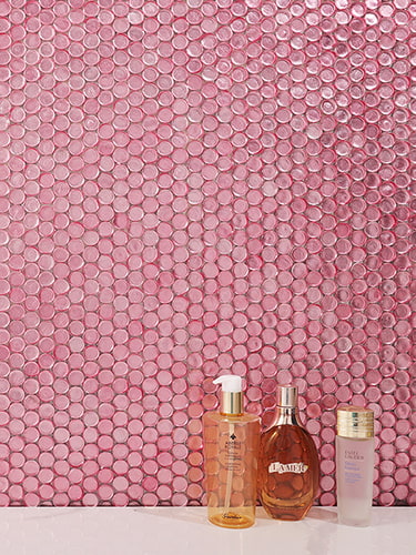 Close up of pink penny glass mosaic tiles reflecting light