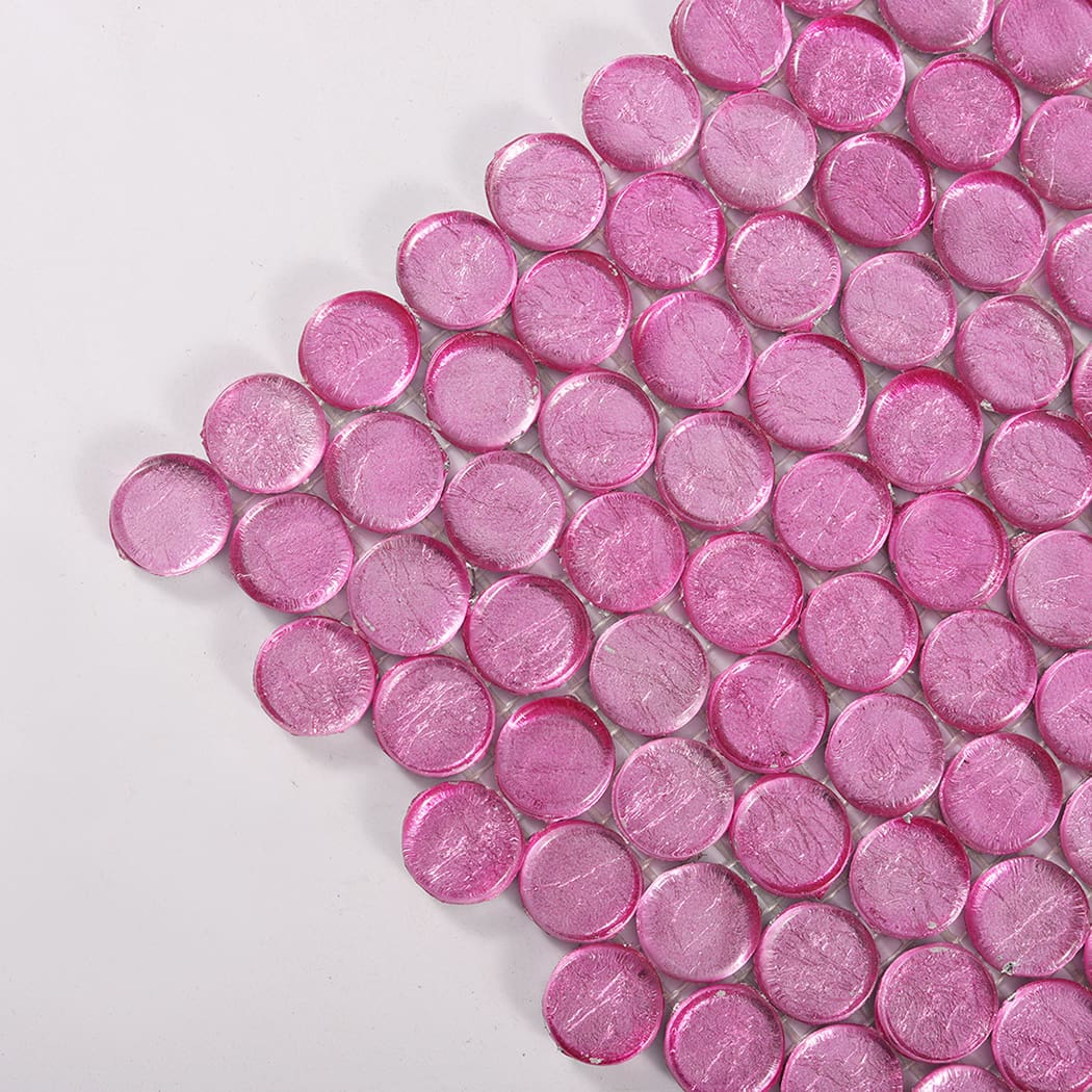 Close-up of pink round glass mosaic tiles highlighting glossy surface texture