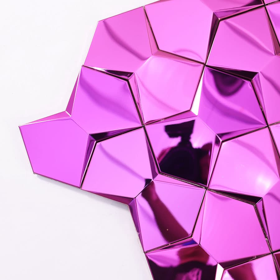 Corner close up of purple 3D stainless steel wall tile