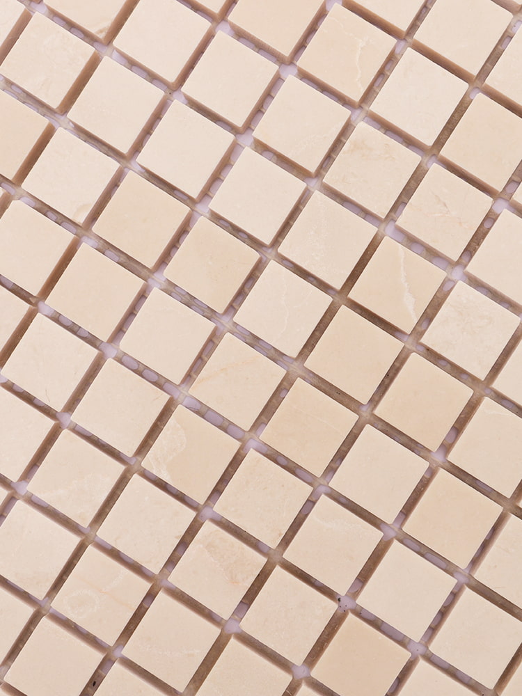 Queen beige marble mosaic tiles arranged in a grid pattern with soft veining and subtle texture.