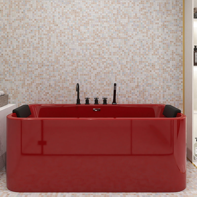 Red bathtub with black faucets and a beige mosaic tile wall in the background