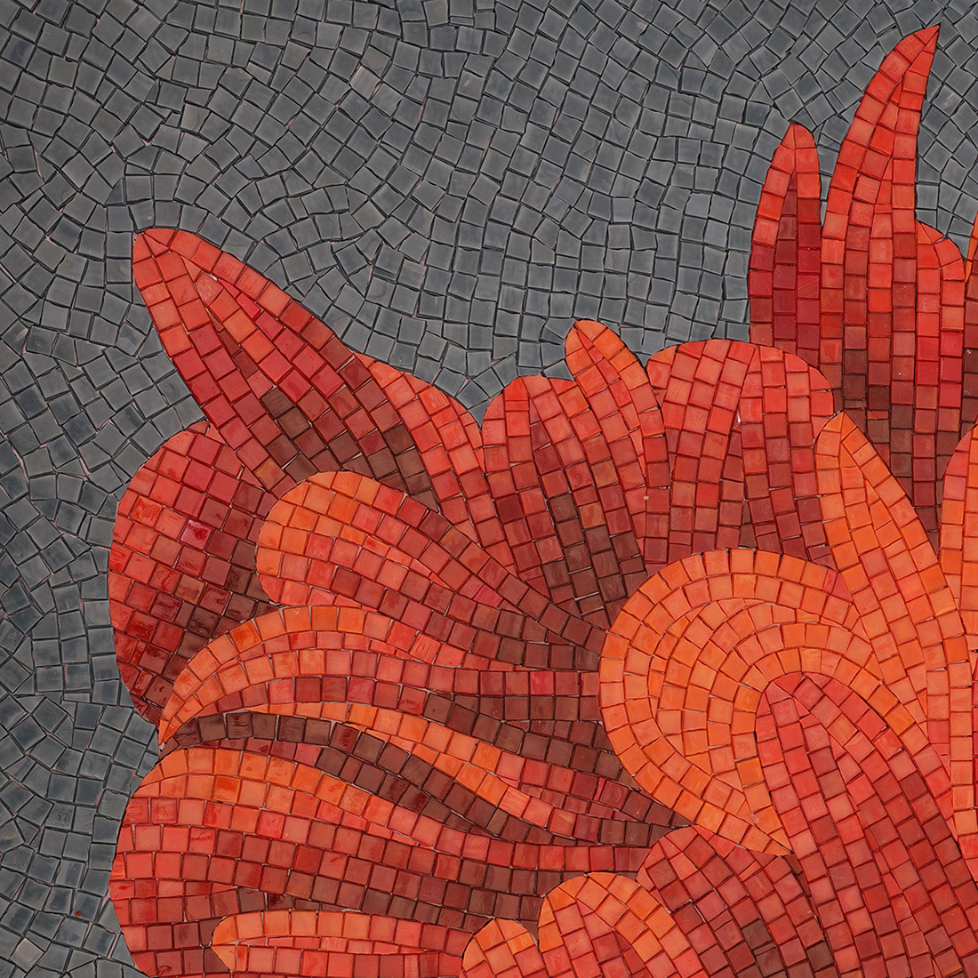 Red floral glass mosaic detail with gray background and curved tile layout