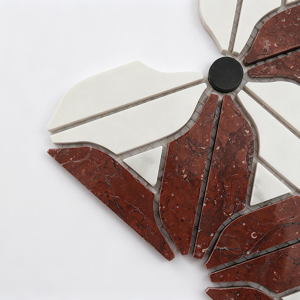 Close-up of red marble floral mosaic tile with white petals and black accents