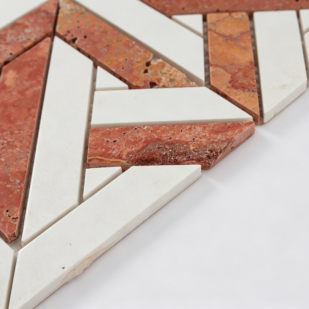 Side view of red travertine and white marble geometric mosaic tile pieces