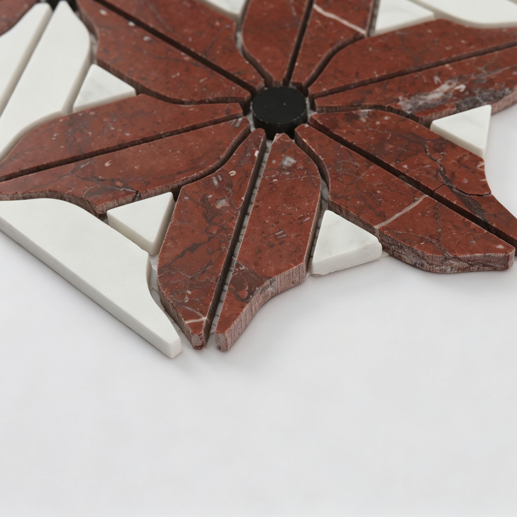 Side view of red and white marble floral mosaic tile with black accents