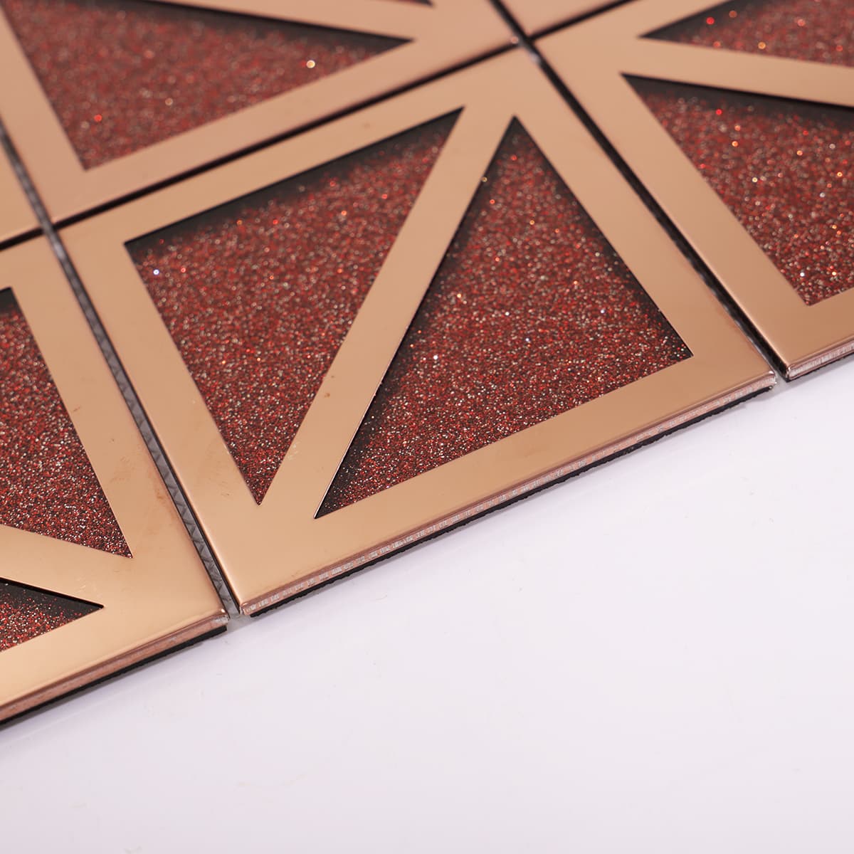 Side view of red glitter tile with rose gold frame