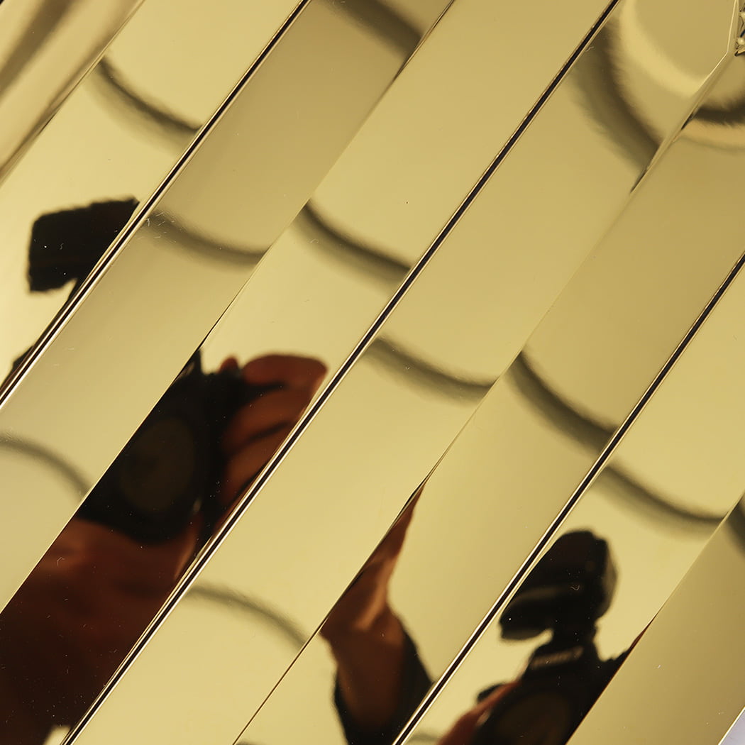 Detail of the highly reflective mirror finish on gold 3D linear metal mosaic tiles.