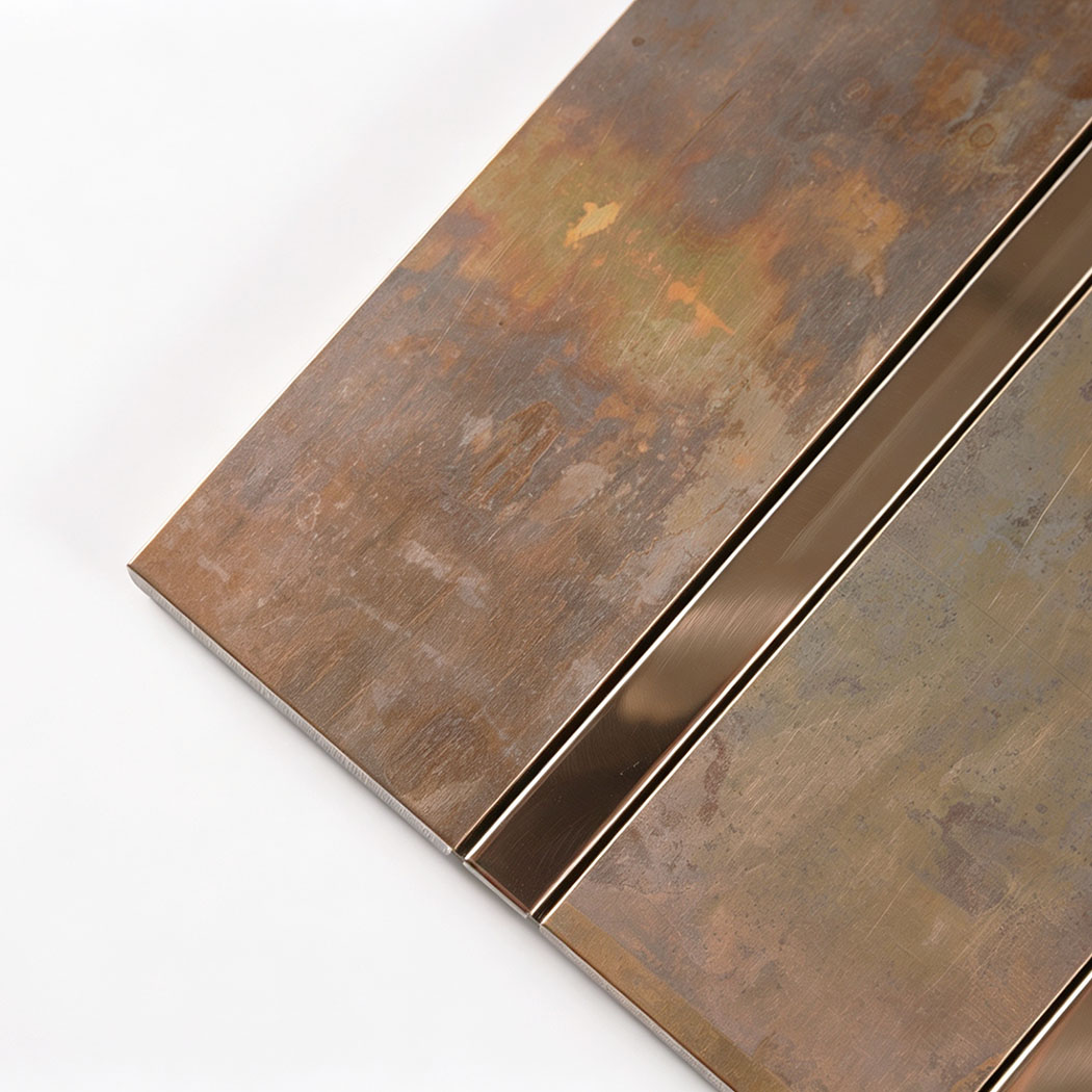 Corner close-up of retro copper metal tile with textured panels