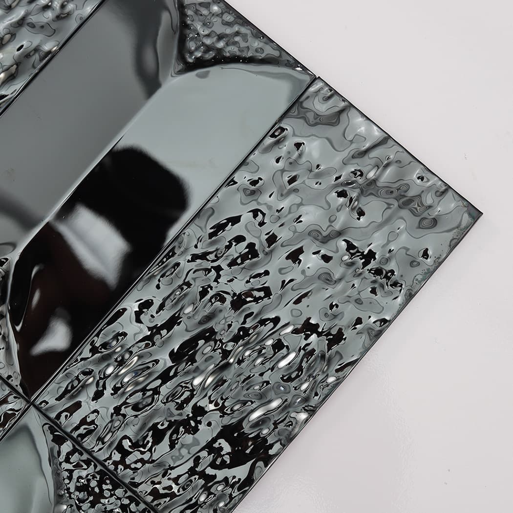 Extreme close up of the highly reflective, rippled texture on a black 3D stainless steel tile.