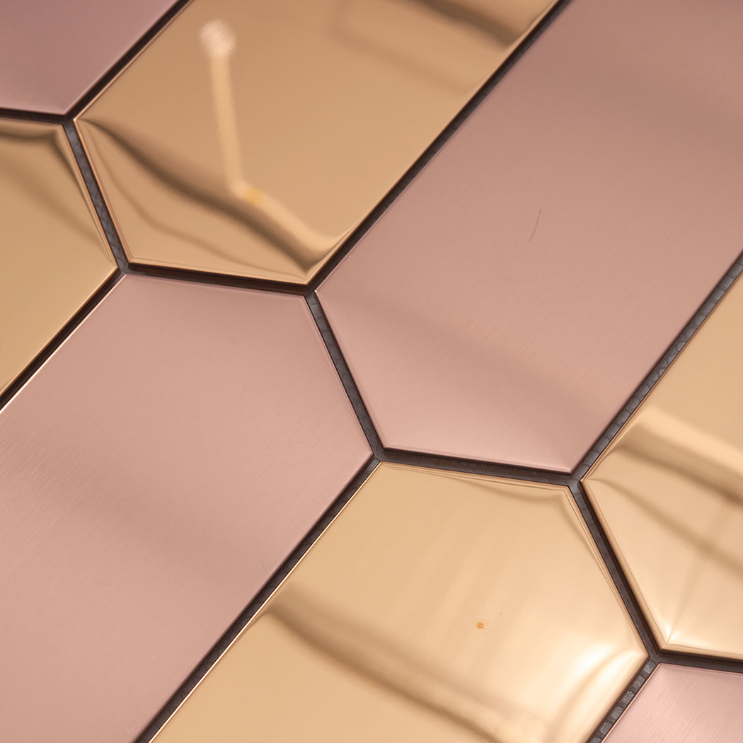 Angled view of rose gold brushed and mirror elongated hexagon mosaic tile sheet