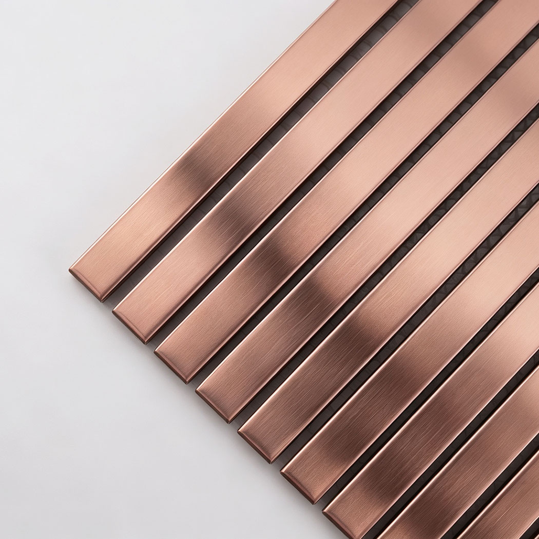 Corner close-up of rose gold brushed stainless steel ribbed tile