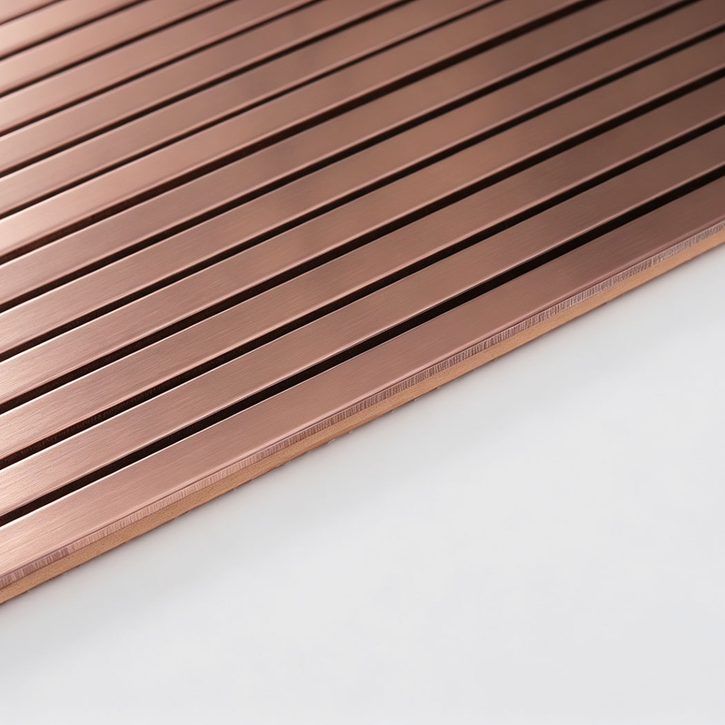 Edge detail of rose gold brushed stainless steel ribbed tile sheet