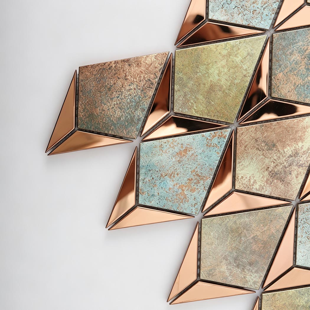 Close up of rose gold metal and antique finished diamond mosaic tile