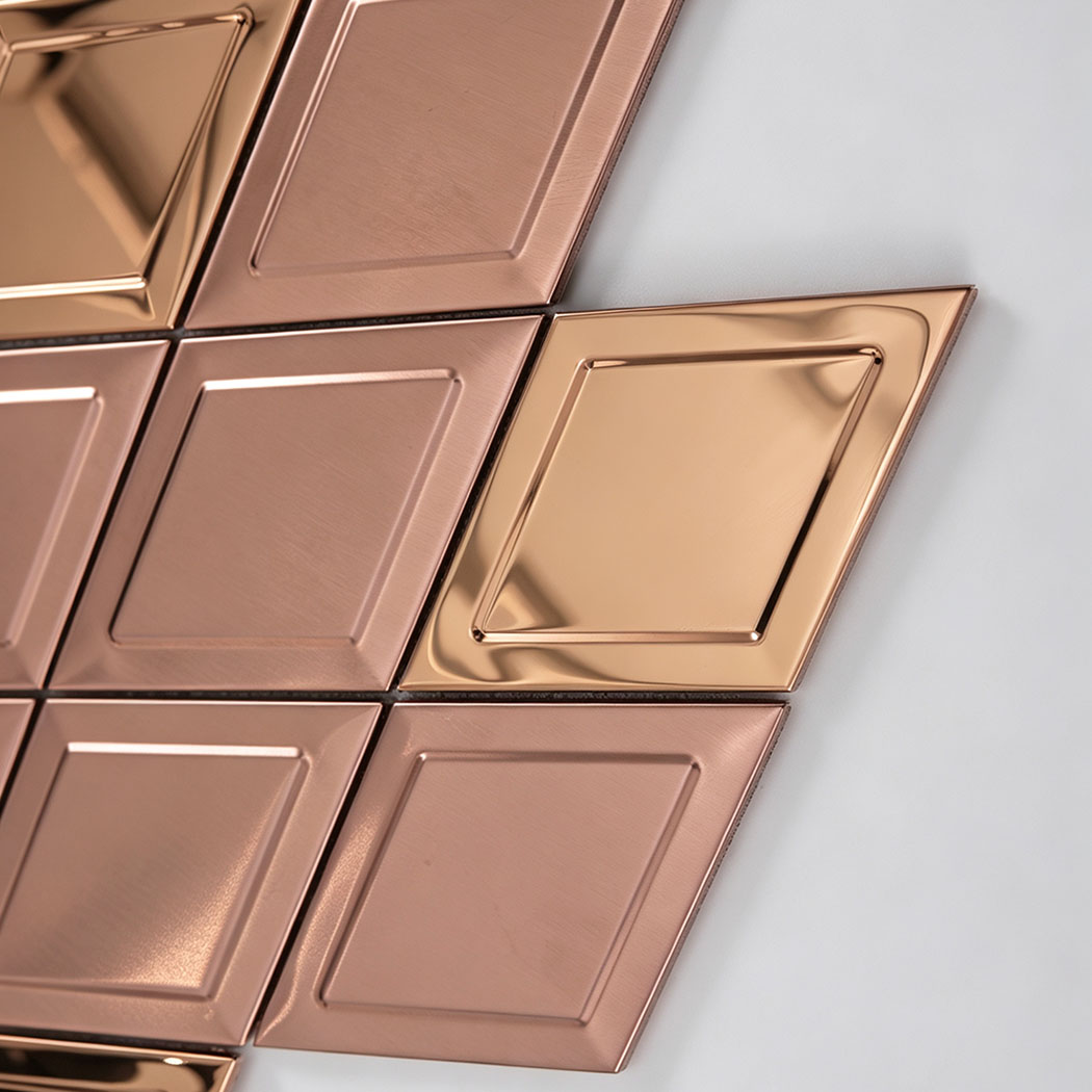 Close up of rose gold diamond stainless steel mosaic tiles with raised geometric detail