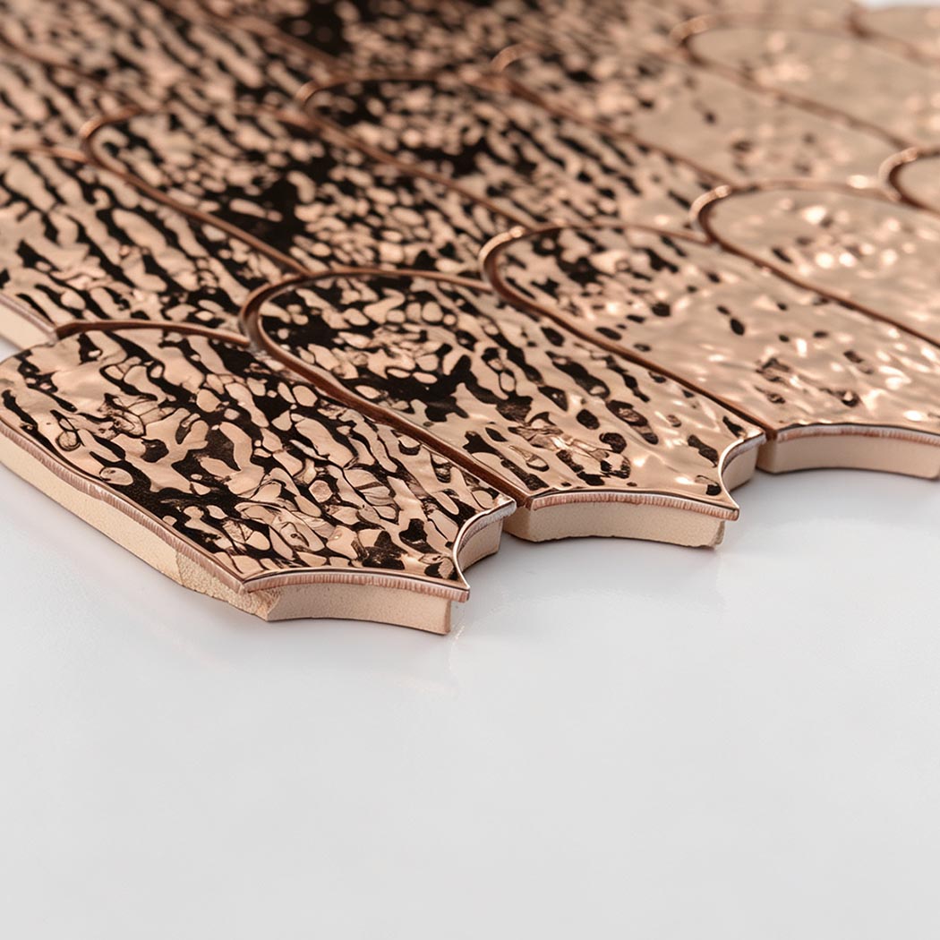 Side detail showing the thickness of rose gold hammered scallop mosaic tiles