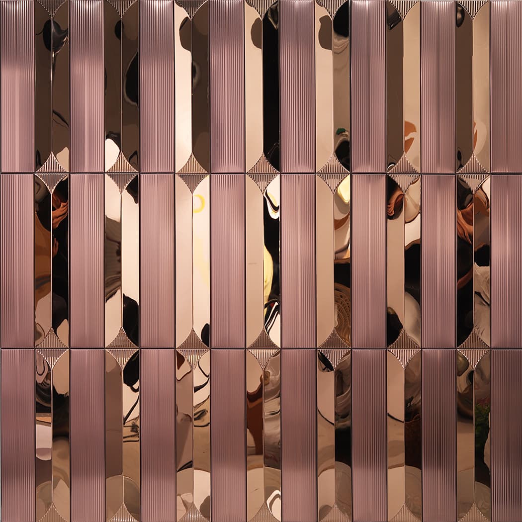 Multiple rose gold linear mosaic tiles installed on a wall creating a repeating pattern.