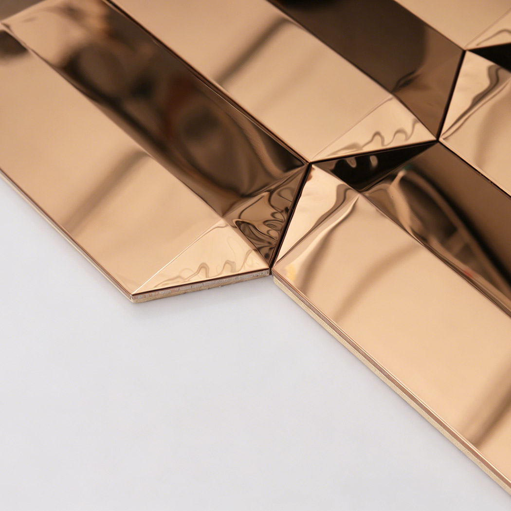 Side close up of rose gold mirror mosaic tile showing thickness and beveled edges