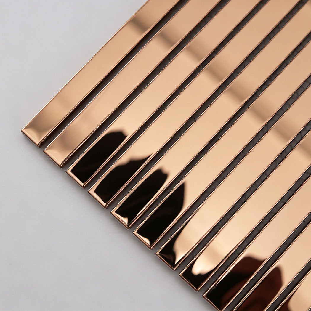 Corner close-up of rose gold mirror stainless steel linear tile