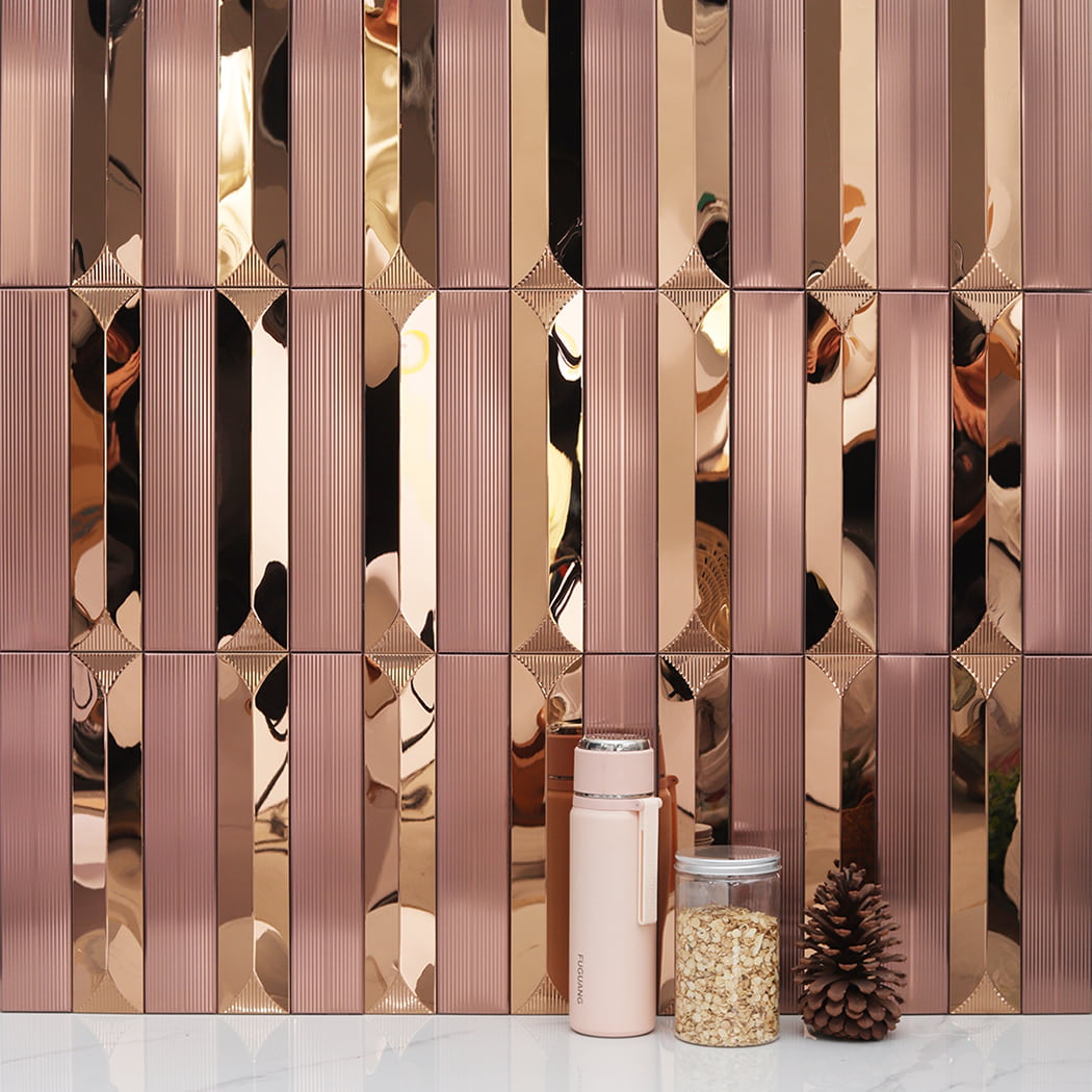 Rose gold mosaic backsplash with a thermos and glass jar on a white marble countertop.