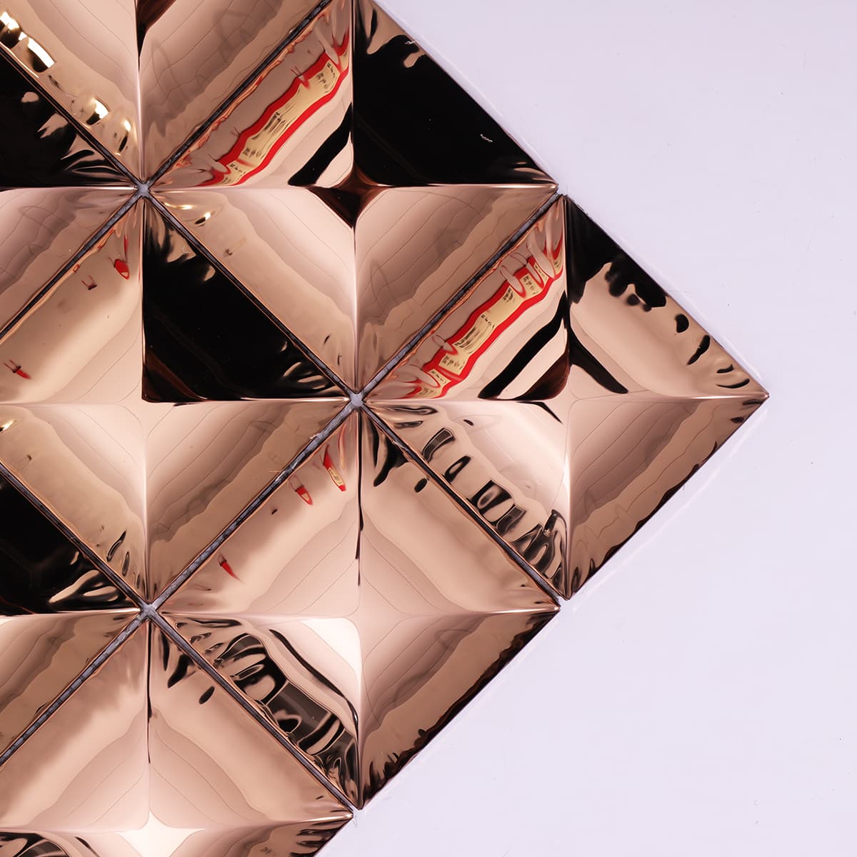 Close-up of rose gold pyramid metal mosaic from corner