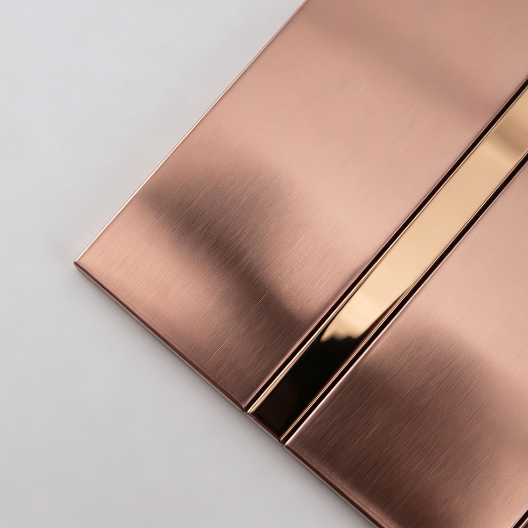 Corner close-up of rose gold stainless steel striped tile strips