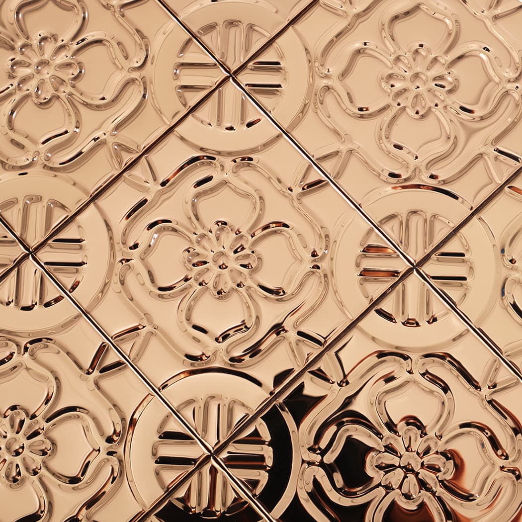 Detailed view of rose gold embossed floral pattern across tile grid