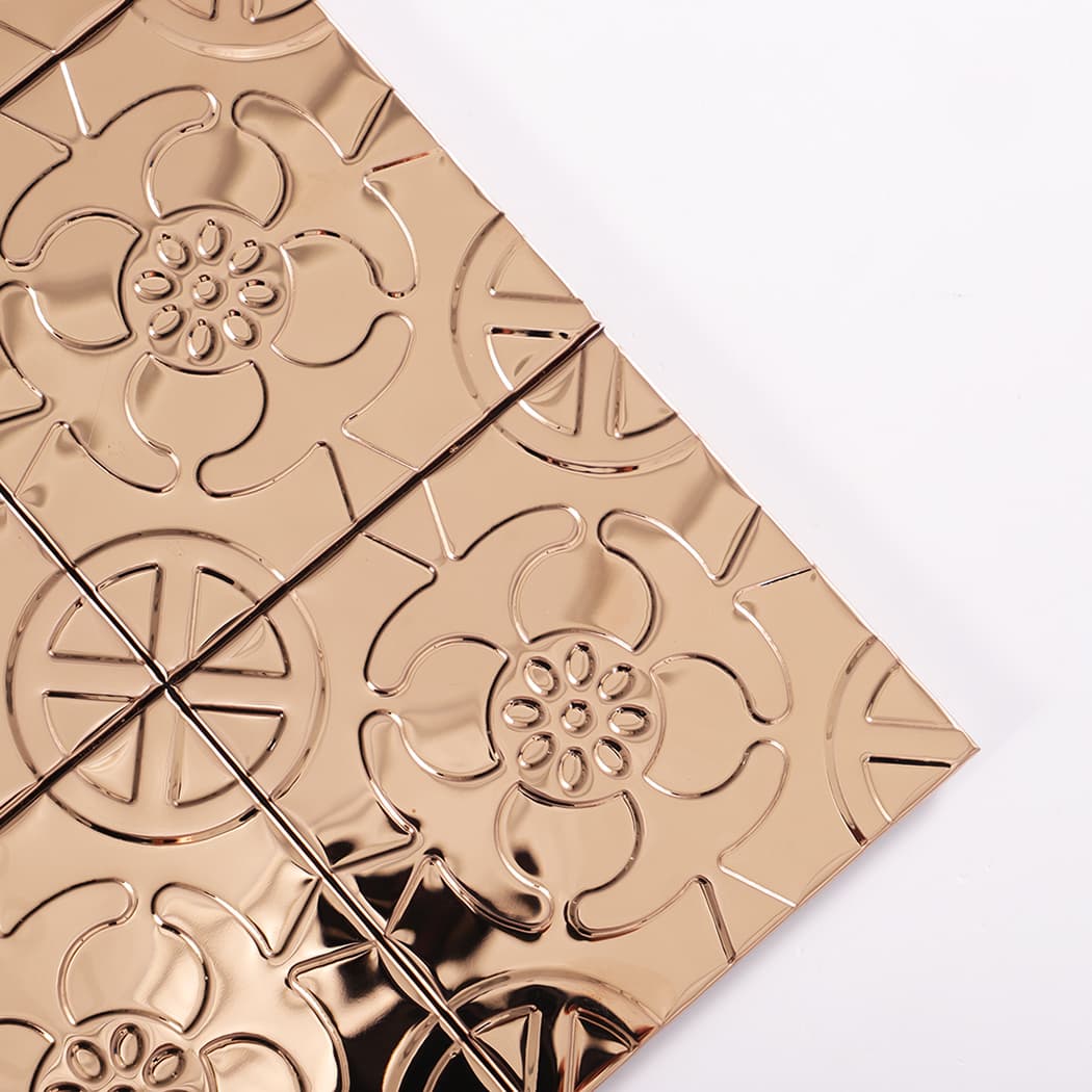 Diagonal corner detail highlighting rose gold embossed flower and crisp grout lines