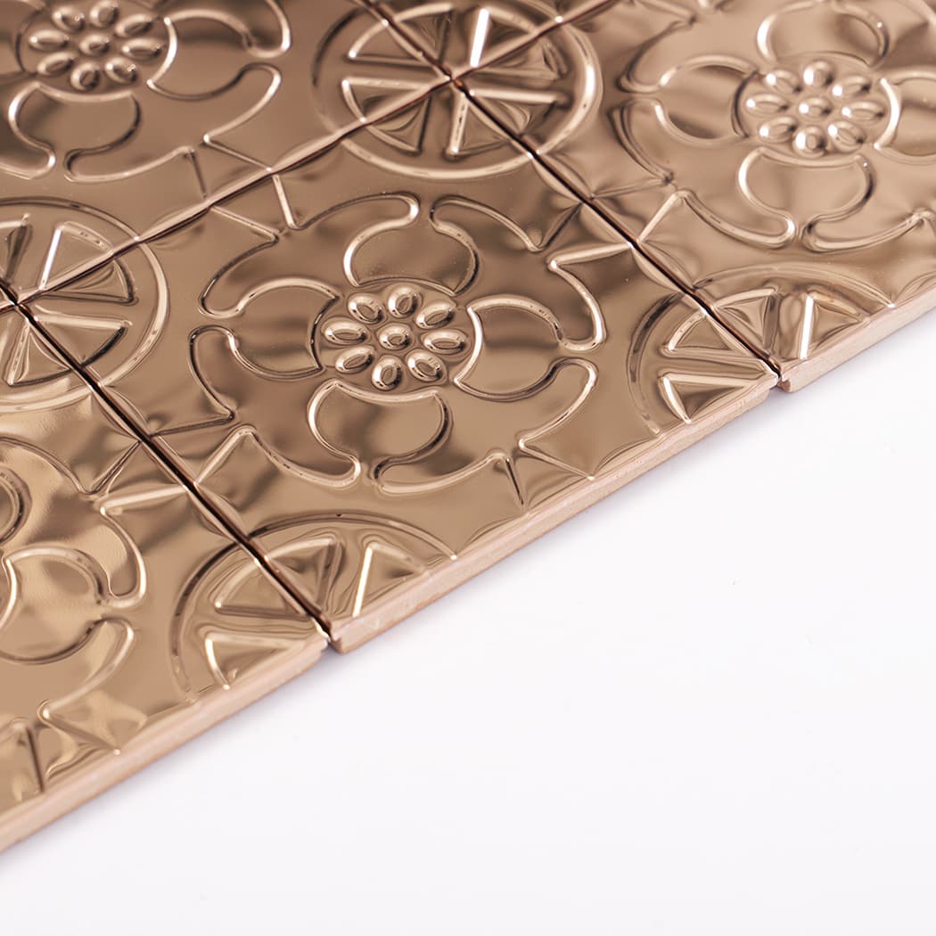 Side profile close up of rose gold embossed tile sheet showing edge thickness and sheen