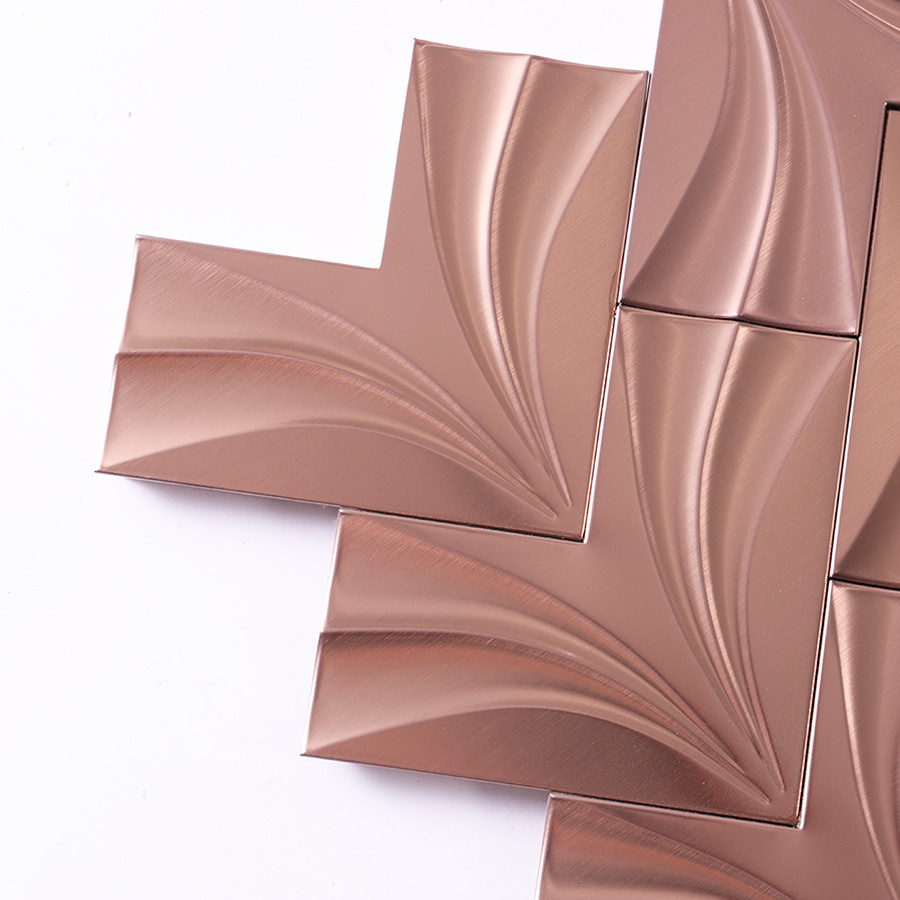 Close up corner of rose gold herringbone stainless steel mosaic tile