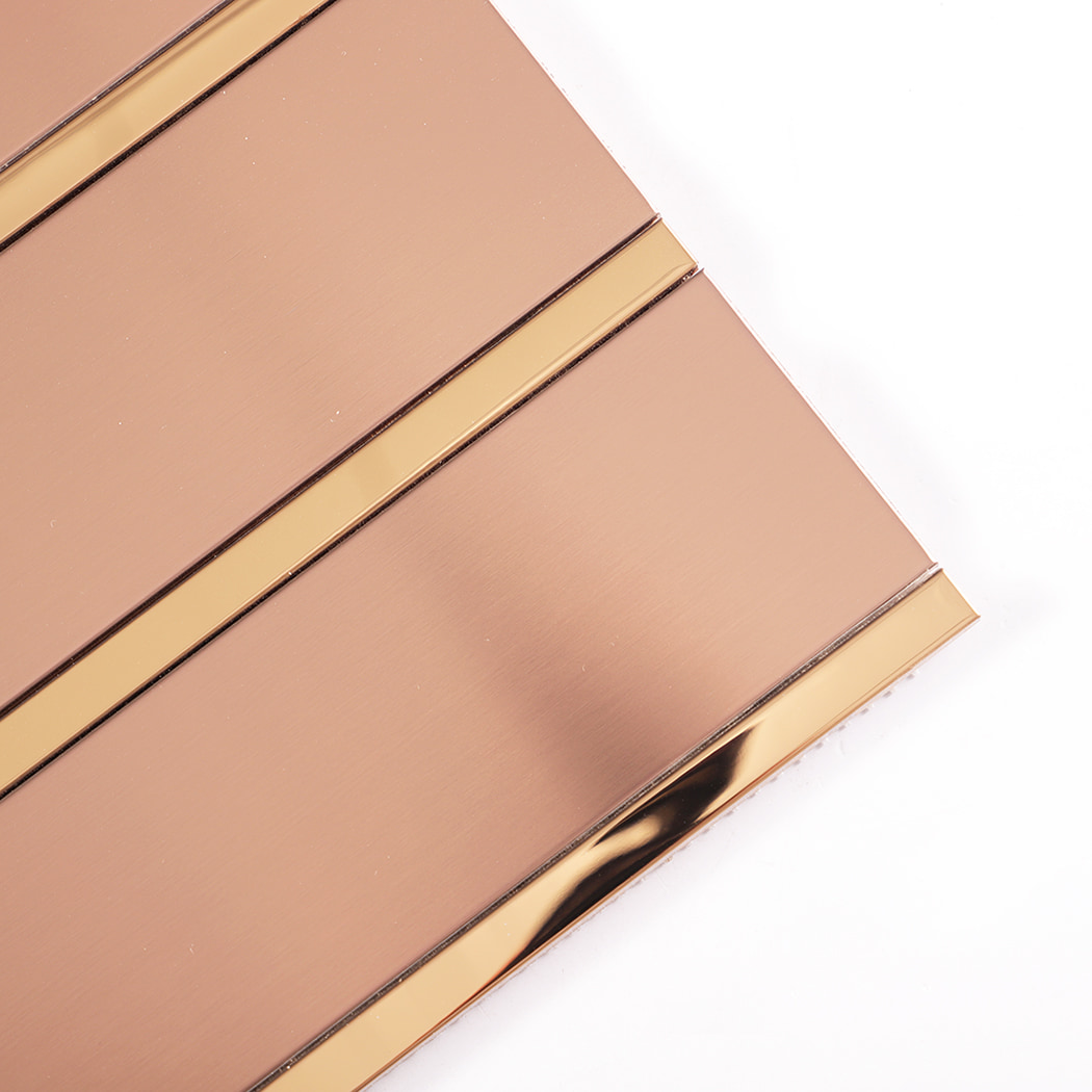 Angled close up of rose gold metal tiles with brushed finish