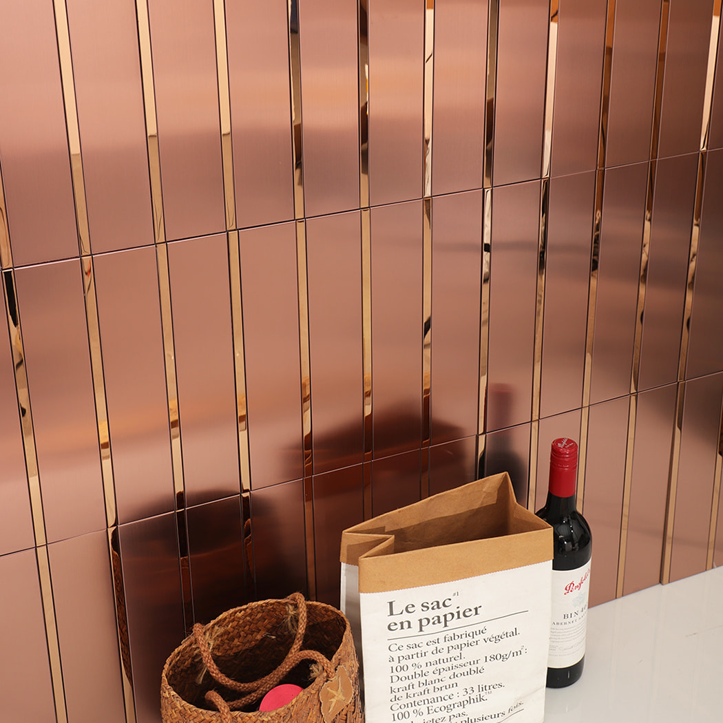 Rose gold metal tile backsplash with decorative items on countertop