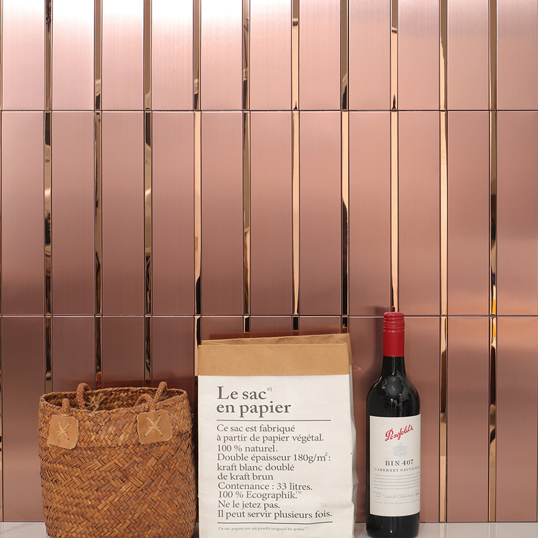 Rose gold metal wall tiles installed in a modern interior setting