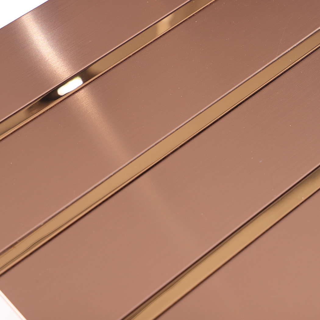 Detailed view of rose gold metal tile surface and glossy trim lines