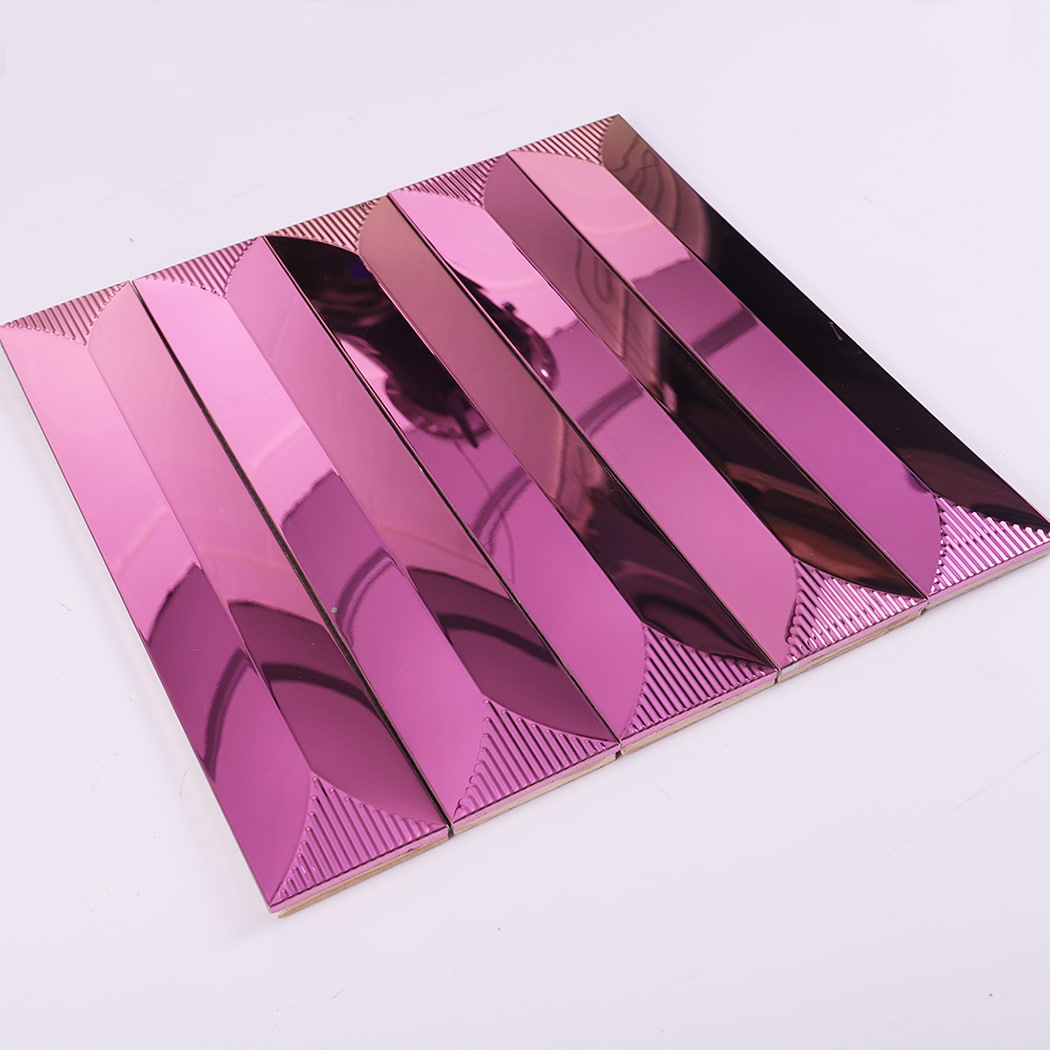 Angled view of rose pink stainless steel subway tile on white background