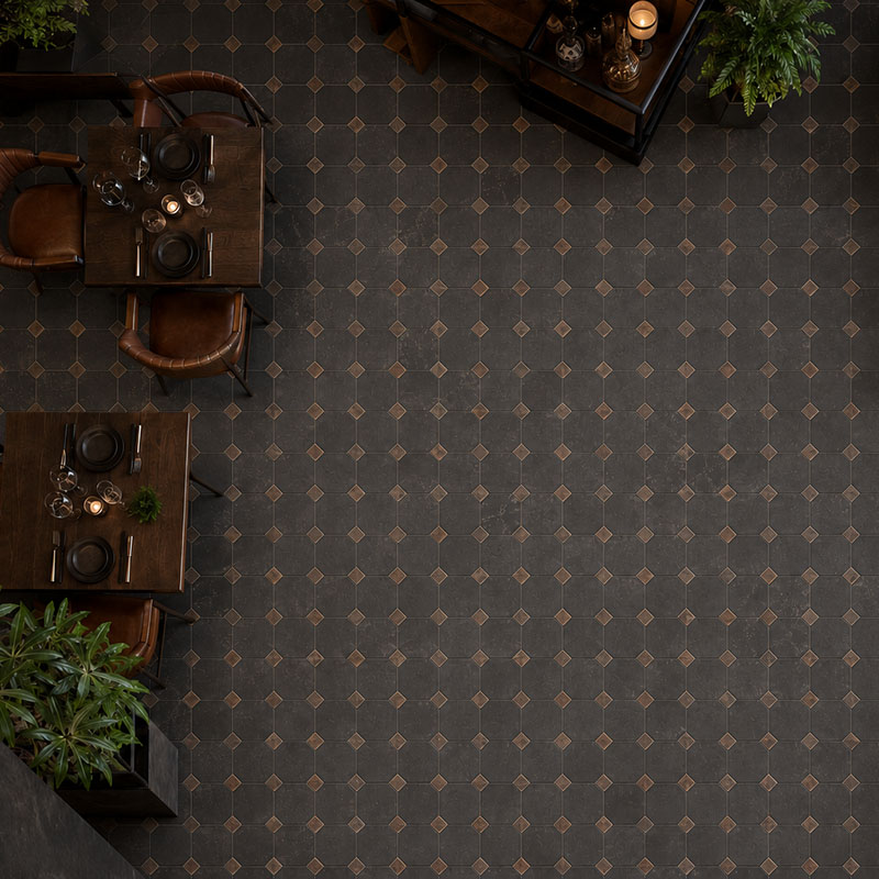 Overhead view of rust slate industrial floor tiles with brown square inlays in a restaurant