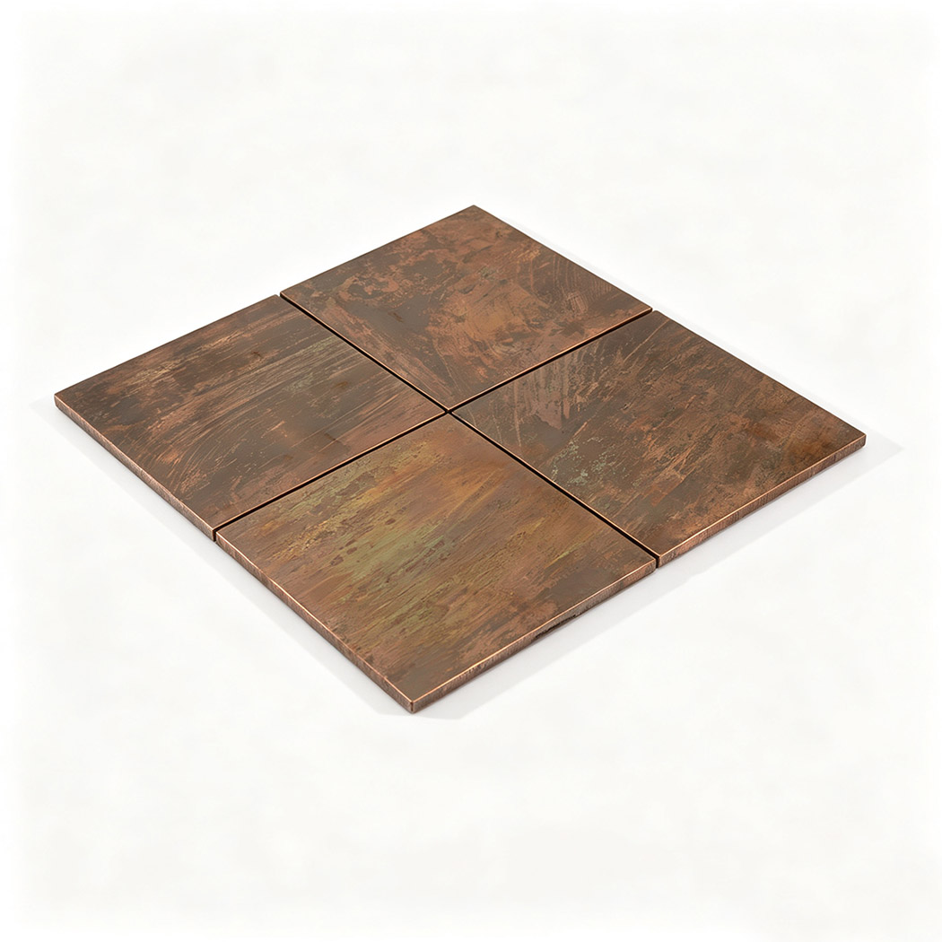Perspective view of four rustic copper square tiles with unique aged metal textures