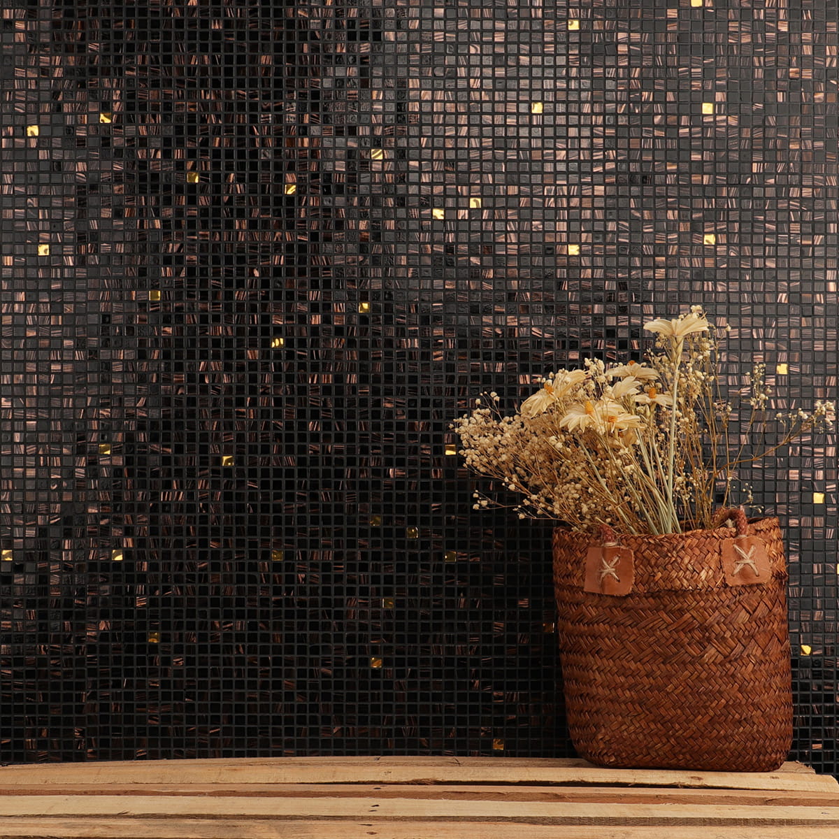 Rustic interior with black mosaic tiles featuring bronze swirls and subtle gold accents