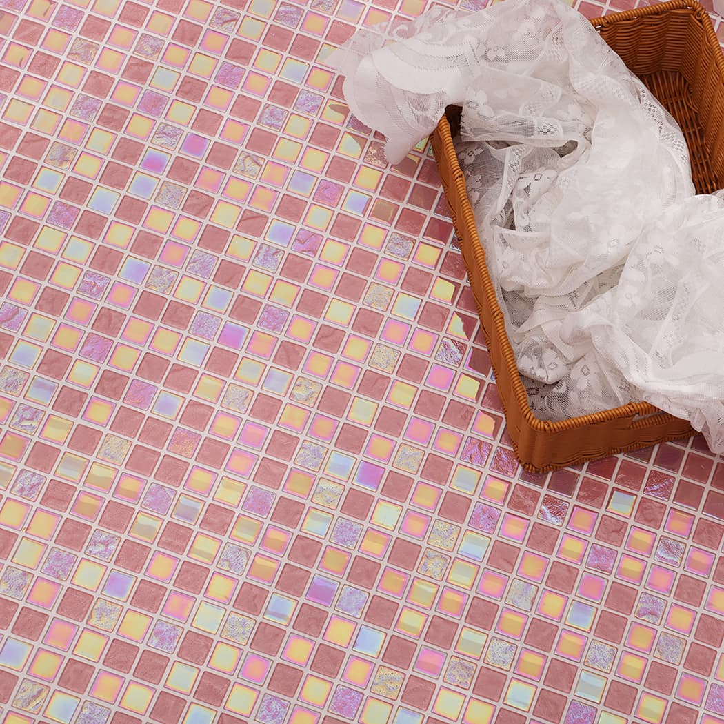 Large area of pink iridescent tiles reflecting light with a decorative lace basket nearby.