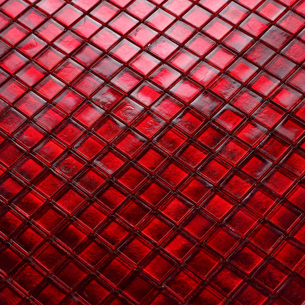 Shiny red mosaic tile surface with a high-gloss finish, reflecting light beautifully