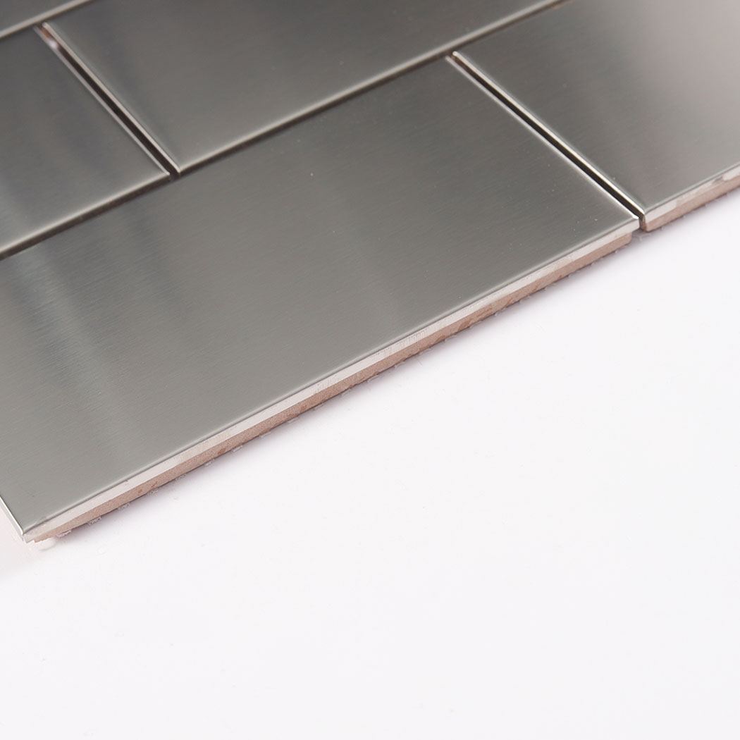 Side view of brushed stainless steel subway tile showing tile edge and thickness