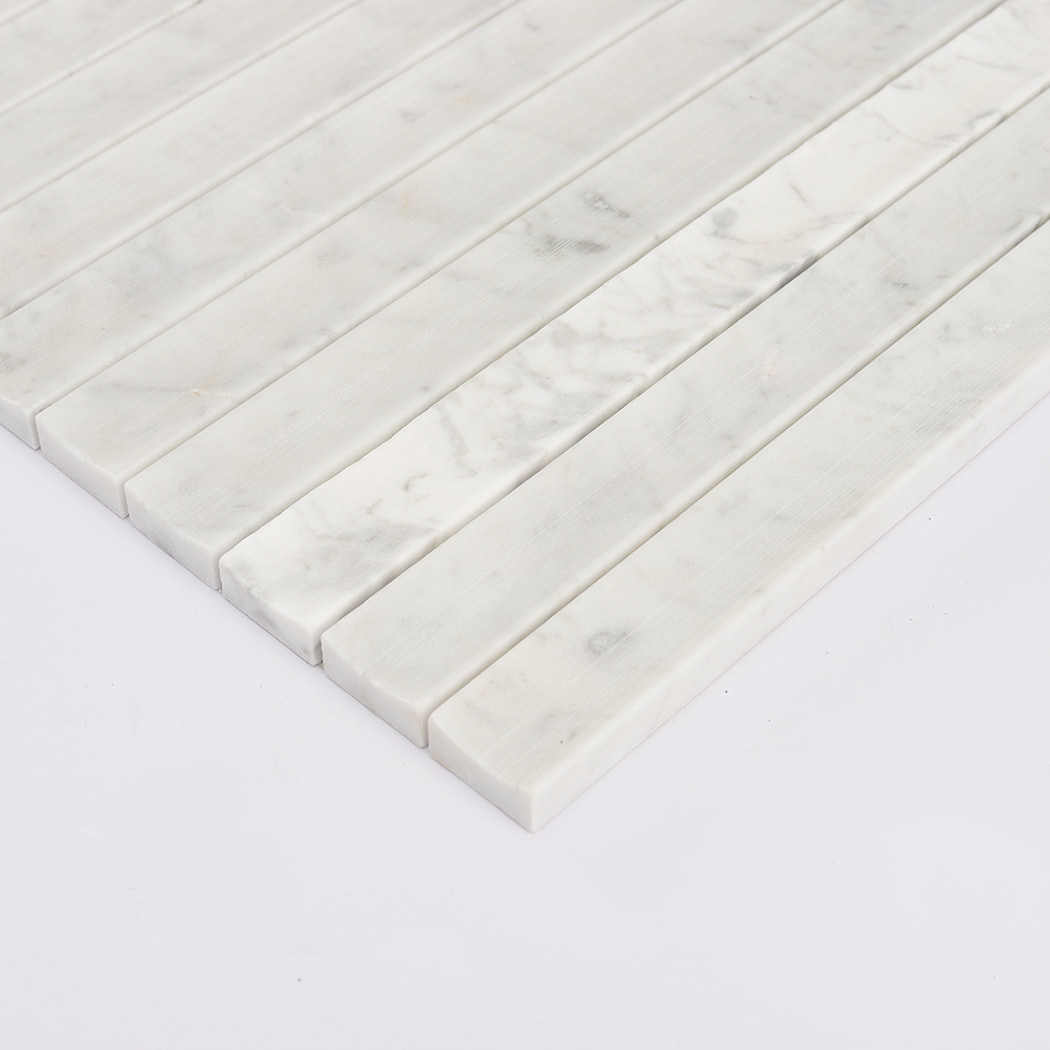 Side angle view highlighting the convex fluted profile of the Carrara White marble tile.